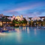 Large resort pool and illuminated Hard Rock Hotel at Universal Orlando at twilight