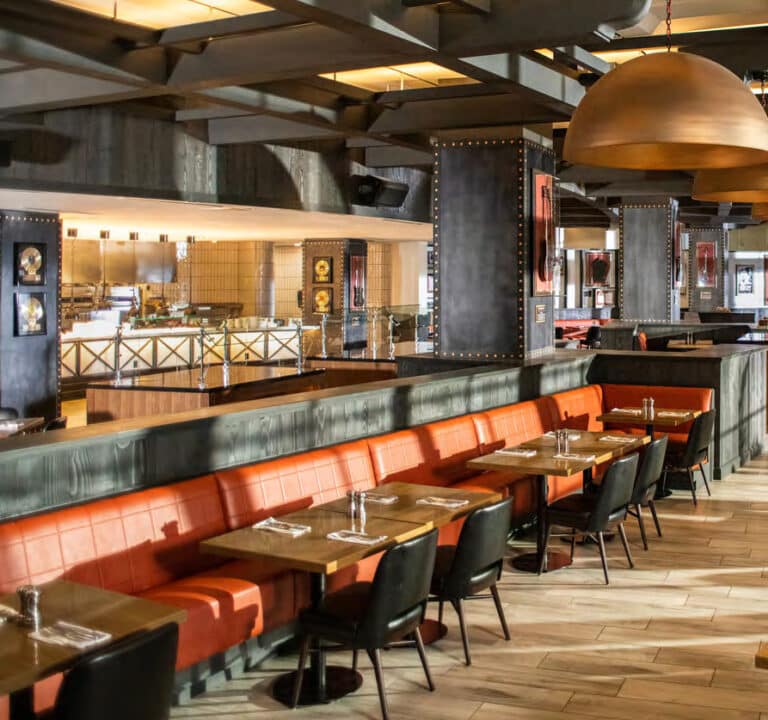 The Kitchen restaurant interior at Hard Rock Hotel at Universal Orlando with orange booths and rock music decor