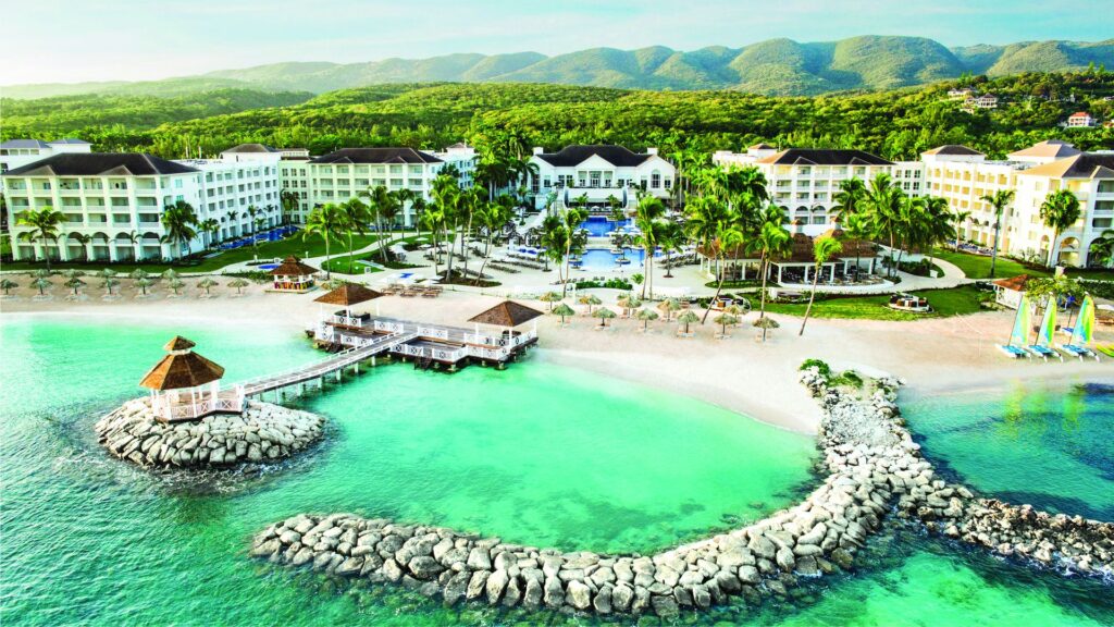 Aerial view of Hyatt Ziva Rose Hall with resort buildings, pools and turquoise beachfront in Montego Bay Jamaica