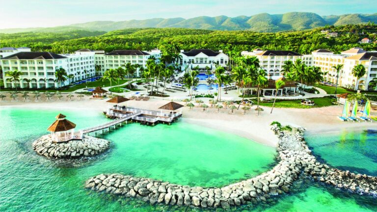 Aerial view of Hyatt Ziva Rose Hall with resort buildings, pools and turquoise beachfront in Montego Bay Jamaica
