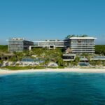 Aerial view of Impression Moxché by Secrets with beachfront resort buildings and pools in Playa del Carmen