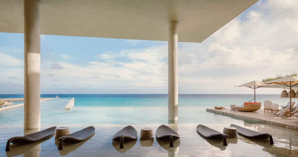 Oceanfront infinity pool and lounge terrace at La Casa de la Playa by Xcaret in Riviera Maya, Mexico