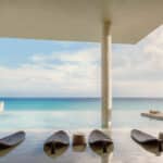 Oceanfront infinity pool and lounge terrace at La Casa de la Playa by Xcaret in Riviera Maya, Mexico