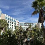 Blue-roofed guest buildings and tropical landscaping at Loews Sapphire Falls Resort in Universal Orlando