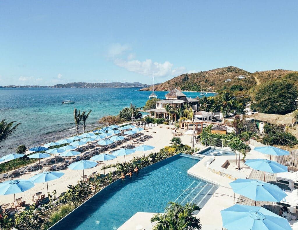 Infinity pool and waterfront beach club at Lovango Resort on its private island in the U.S. Virgin Islands