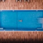 Top-down view of the freshwater pool and wood deck at Manchebo Beach Resort in Aruba