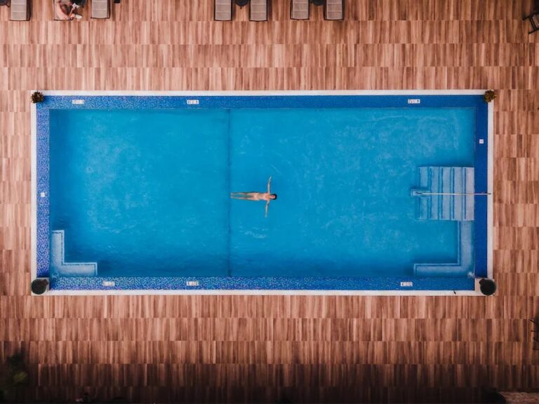 Top-down view of the freshwater pool and wood deck at Manchebo Beach Resort in Aruba