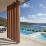 Ocean-facing infinity pool terrace at Mandarin Oriental Canouan overlooking the turquoise Caribbean Sea