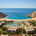 Aerial view of Montage Los Cabos with pools and resort buildings around Santa Maria Bay