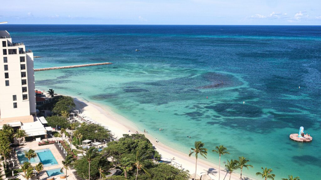 Aerial view of The Ritz-Carlton Aruba beside Palm Beach and turquoise Caribbean water