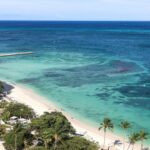 Aerial view of The Ritz-Carlton Aruba beside Palm Beach and turquoise Caribbean water