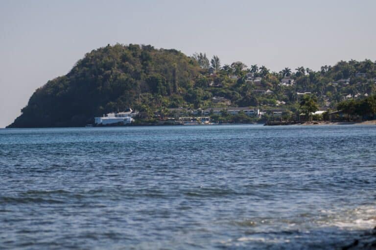 Round Hill Hotel and Villas spread across a green Jamaican hillside above the blue Caribbean Sea