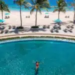 Sandals Barbados pool overlooking palm trees and the white sand of Dover Beach