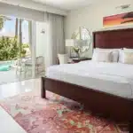 King bedroom opening to a Crystal Lagoon swim-up pool at Sandals Halcyon Beach
