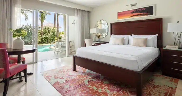 King bedroom opening to a Crystal Lagoon swim-up pool at Sandals Halcyon Beach
