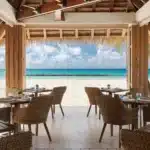 Open-air beachfront restaurant dining at Sandals Royal Barbados overlooking the Caribbean Sea