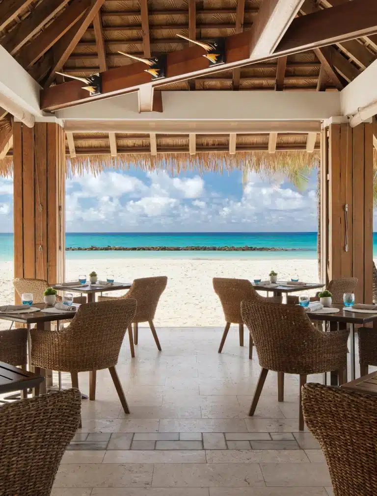 Open-air beachfront restaurant dining at Sandals Royal Barbados overlooking the Caribbean Sea