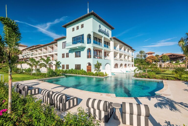 Sandals Royal Curaçao resort building and pool beneath a bright Caribbean sky