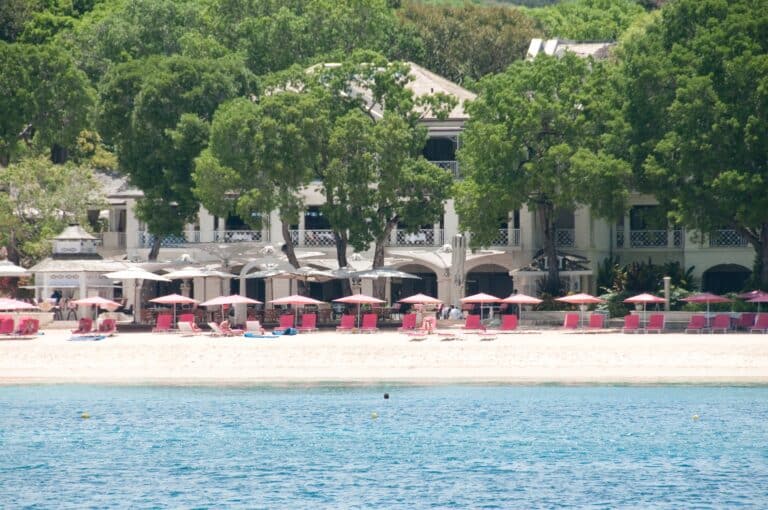 Sandy Lane resort beachfront with pink loungers, white sand and turquoise water in Barbados