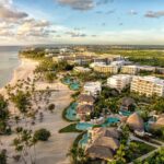 Aerial view of Secrets Cap Cana Resort & Spa with pools, resort buildings and beachfront in the Dominican Republic