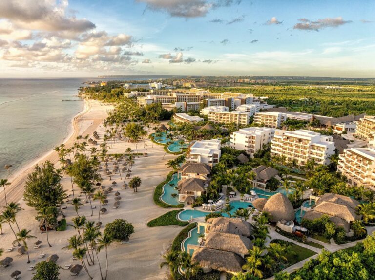 Aerial view of Secrets Cap Cana Resort & Spa with pools, resort buildings and beachfront in the Dominican Republic