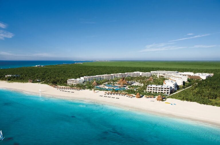 Aerial view of Secrets Maroma Beach Riviera Cancun beside a wide white-sand beach and turquoise water