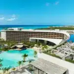 Aerial view of Secrets Moxché Playa del Carmen with lagoon-style pools and the Caribbean Sea