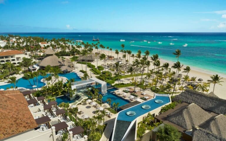 Aerial view of Secrets Royal Beach Punta Cana with pools, palm trees and the Caribbean beachfront