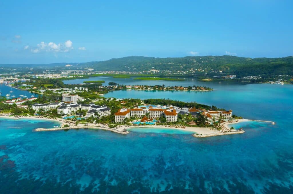 Aerial view of Secrets St. James Montego Bay on a tropical peninsula in Jamaica
