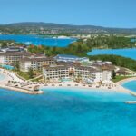 Aerial view of Secrets Wild Orchid Montego Bay surrounded by bright Caribbean water in Jamaica