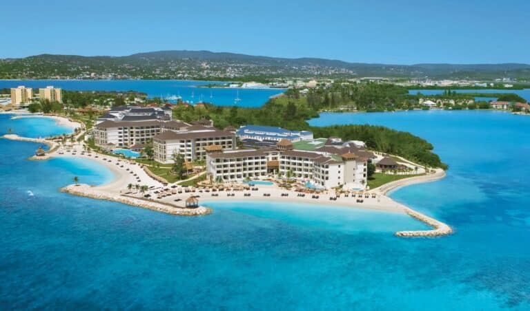 Aerial view of Secrets Wild Orchid Montego Bay surrounded by bright Caribbean water in Jamaica