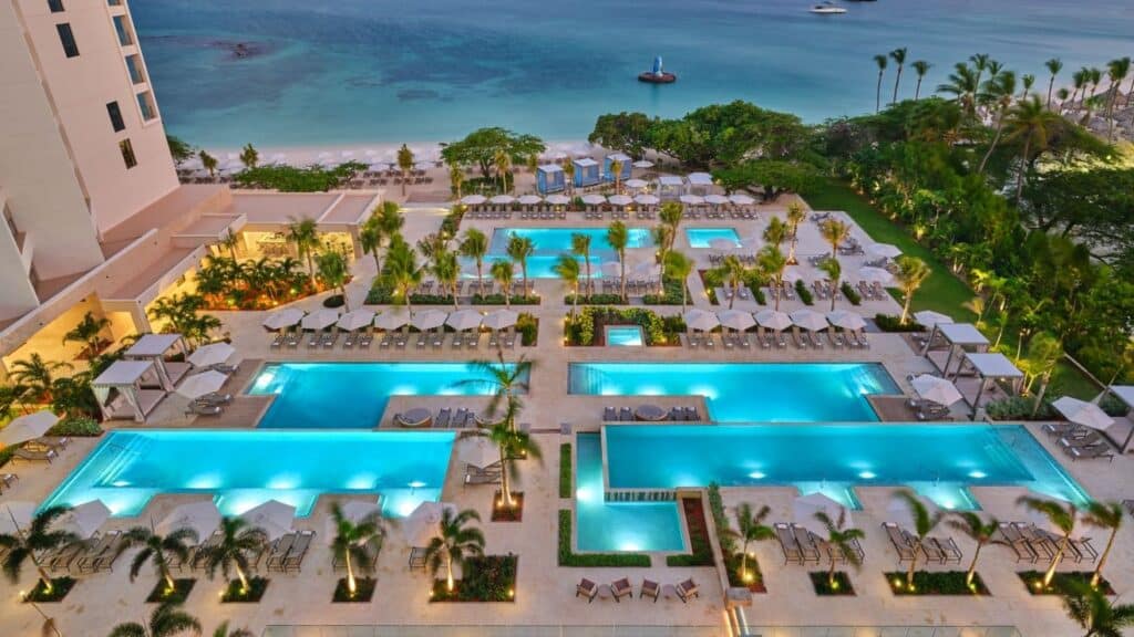 Aerial view of the pools, cabanas, Palm Beach and Caribbean Sea at The St. Regis Aruba Resort