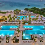 Aerial view of the pools, cabanas, Palm Beach and Caribbean Sea at The St. Regis Aruba Resort