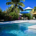 Blue swimming pool, palms and colorful resort buildings at Staniel Cay Yacht Club in the Exumas, Bahamas