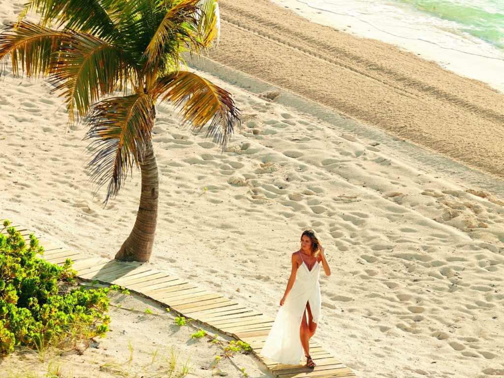 Long Bay Beach, palm tree and beachfront walkway at The Shore Club Turks and Caicos