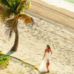 Long Bay Beach, palm tree and beachfront walkway at The Shore Club Turks and Caicos