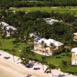 Aerial view of yellow Tortuga Bay villas along the white-sand beach in Punta Cana, Dominican Republic