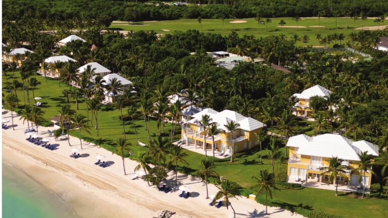 Aerial view of yellow Tortuga Bay villas along the white-sand beach in Punta Cana, Dominican Republic