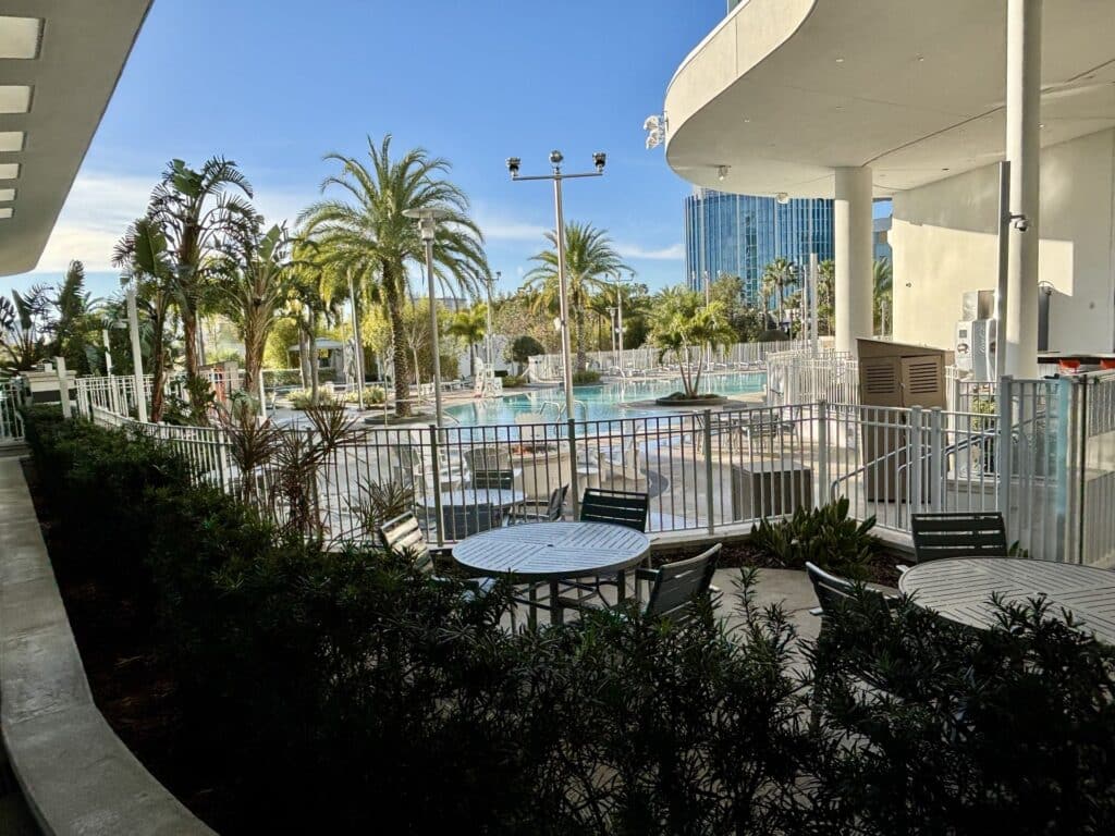 Pool area with the blue glass tower of Universal's Aventura Hotel in Orlando
