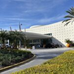 Retro white entrance building and palm landscaping at Universal's Cabana Bay Beach Resort in Orlando