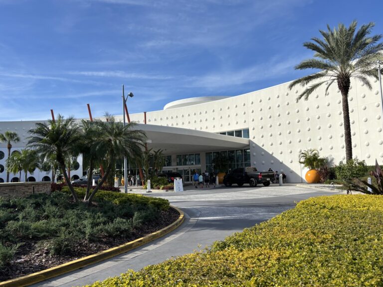 Retro white entrance building and palm landscaping at Universal's Cabana Bay Beach Resort in Orlando