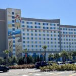 Surfside Inn and Suites tower with colorful surf mural and palm trees at Universal Orlando Resort