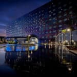 Illuminated exterior and reflecting pool at Universal Stella Nova Resort at Universal Orlando