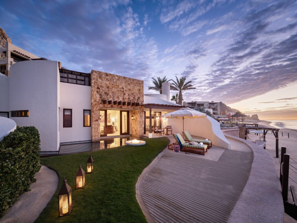 Waldorf Astoria Los Cabos Pedregal resort terrace and buildings overlooking the Pacific coast at dusk