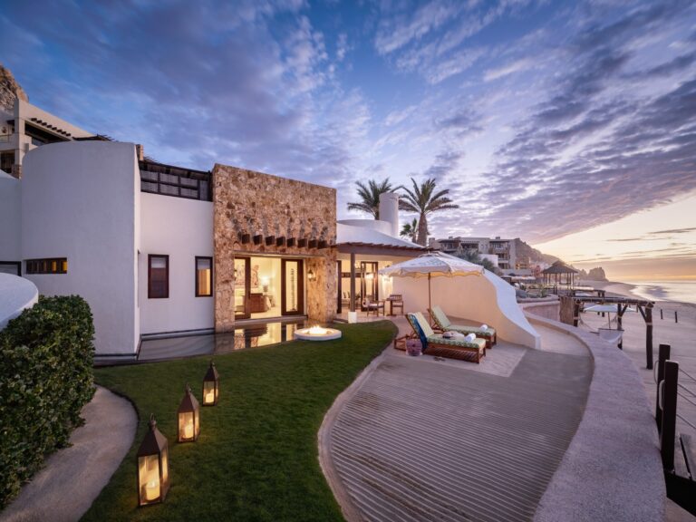 Waldorf Astoria Los Cabos Pedregal resort terrace and buildings overlooking the Pacific coast at dusk