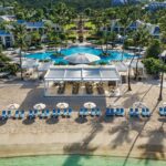 Aerial view of the beachfront pool, palms and villas at The Westin St. John Resort Villas in the U.S. Virgin Islands